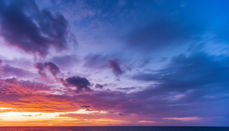 Captivating sunset with a spectrum of pink and blue hues over a tranquil seaの素材