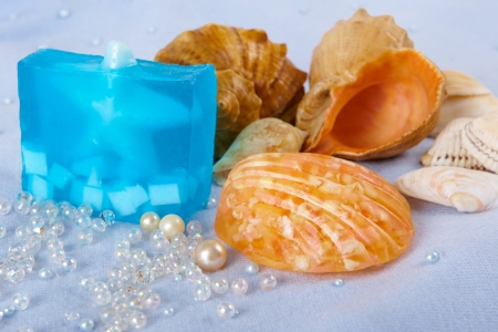Natural skincare products of  exfoliating scrub, soap and sea shells on a blue backgroundの写真素材