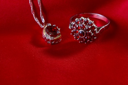 jewelery luxury ruby pendant and ring on a red silk の写真素材