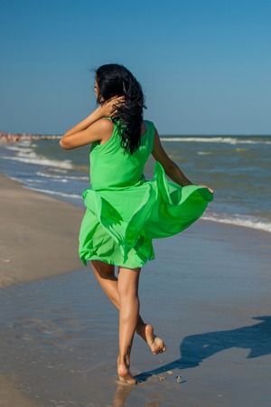 Young cheerful  happiness girl on the Bathing Beach jumping and dancingの写真素材