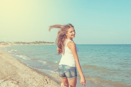 Young cheerful  happiness girl on the Bathing Beachの写真素材
