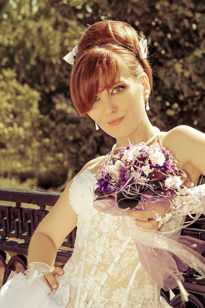 Portrait of a beautiful redhead bride with big eyes on a sunny dayの写真素材