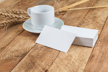 Photo of business cards. Template for branding identity. For graphic designers presentations and portfolios. With wheat spikelets on wooden background.の写真素材