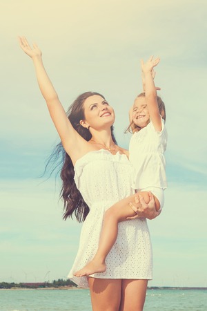 Happy family. Young happy beautiful  mother and her daughter having fun on the beach. Positive human emotions, feelings, emotions.の写真素材