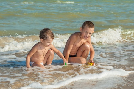 Happy family. Children - two boys having fun on the beach. Positive human emotions, feelings, emotions.の写真素材