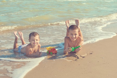 Happy family. Children - two boys having fun on the beach. Positive human emotions, feelings, emotions.の写真素材