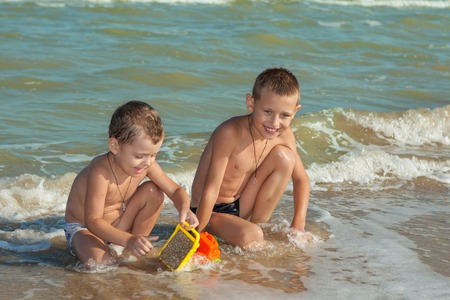 Happy family. Children - two boys having fun on the beach. Positive human emotions, feelings, emotions.の写真素材