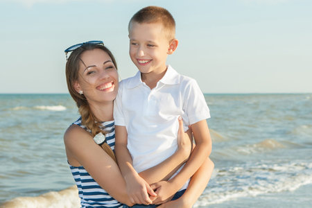 Happy family. Young happy beautiful  mother and her son having fun on the beach. Positive human emotions, feelings, emotions.の写真素材