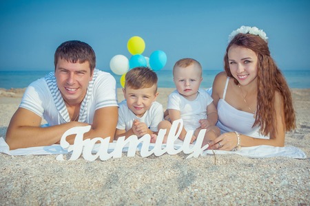 Happy family. Young happy beautiful  parents and their children having fun on the beach. Positive human emotions, feelings, emotions.の写真素材