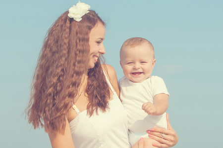 Happy family. Young happy beautiful  mother and her son having fun on the beach. Positive human emotions, feelings.の写真素材