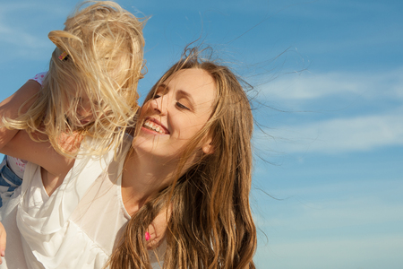 Happy family. Young happy beautiful  mother and her daughter  having fun on the beach. Positive human emotions, feelings, emotions.の写真素材