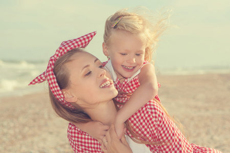 Happy family. Young happy beautiful  mother and her daughter  having fun on the beach. Positive human emotions, feelings, emotions.の写真素材