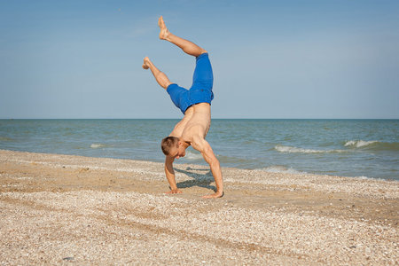 Young man jumping, fun sports on beach