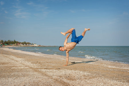 Young man jumping, fun sports on beach