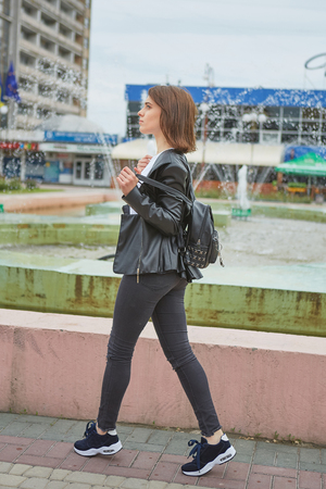 Beautiful young Fashion woman Walk in the city park.の写真素材