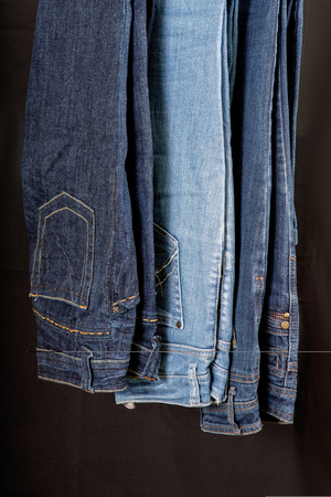 Jeans twisted into a roll on a black and white backgroundの写真素材