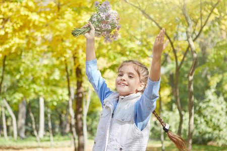 Beautiful happy girl in autumn park. Happy and cheerful.の写真素材