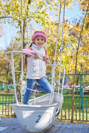 Beautiful happy girl in autumn park. Happy and cheerful.の写真素材