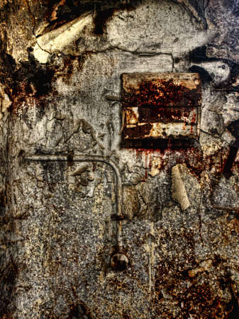 HDR image of an old bathroom wall and paper dispenserの写真素材
