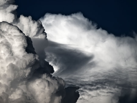 Towering detailed cumulus cloud with lenticular formations