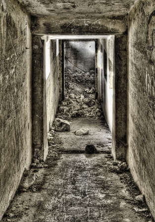 Entrance down to a derelict bunker shot in HDRの写真素材