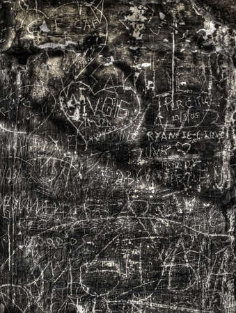 Graffiti and inscriptions on a limestone wall shot in HDRの写真素材