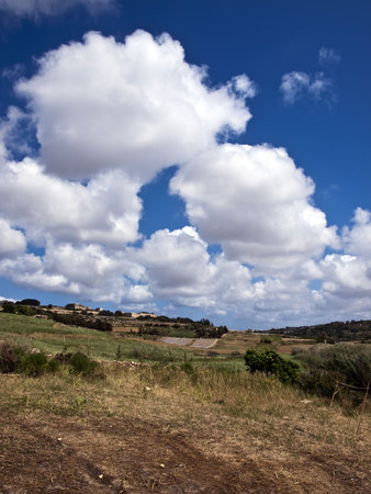 Beautiful sky and clouds over typical valley in Maltaの写真素材