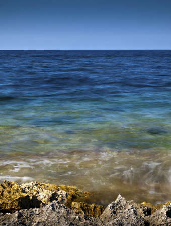 Detail of a rocky reef in Malta with beautiful crystal clear ocean waterの写真素材