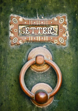An old letterbox and doorknocker on a green door in Mdina in Maltaの写真素材