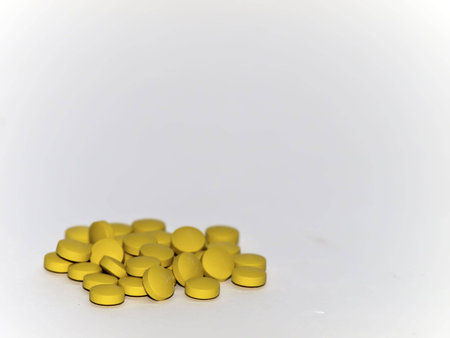 Orange pills over white backdropの写真素材