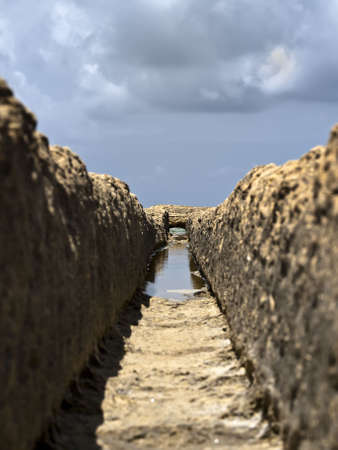 Image shot through rut carved in stone giving impression of a valleyの写真素材