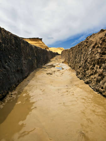 Image shot through rut carved in stone giving impression of a valleyの写真素材
