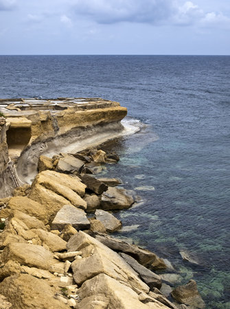Detail from the coastline showing fallen rocks in Gozo in Maltaの写真素材