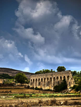 Part of a 19th century colonial aquaduct in Gozo now lying in ruinsの写真素材