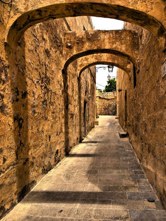 One of the medieval streets in the citadel in Gozo in HDRの写真素材