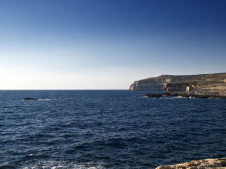 A seascape from Dwejra in Gozo showing Crocodile Rock on the left and the Azure Window on the rightの写真素材