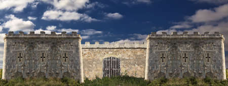 Derelict medieval castle over a cloudy blue skyの写真素材
