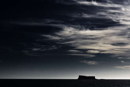 High altitude clouds over a clear sky above a silhouette of Filfla の写真素材