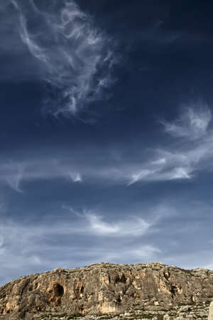 The cliffs at Ghar Lapsi in Malta are a favourite spot for rock climbers and abseilers alike.  The cliff face is spotted with numerous small caves and the view from the top is breathtaking.の写真素材