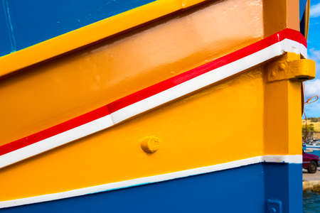 Abstract close up view of the vibrant colours and design usually used on the traditional Maltese fishing boat, the "Dghajsa" or "Luzzu".の写真素材