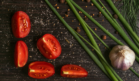 Composition with vegetables and spices on black kitchen tableの写真素材