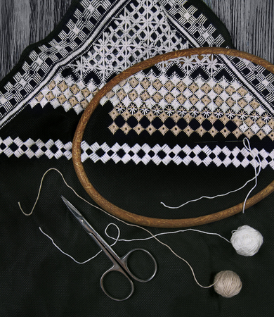 Hardanger embroidery black and white colors with instruments, work in progressの写真素材