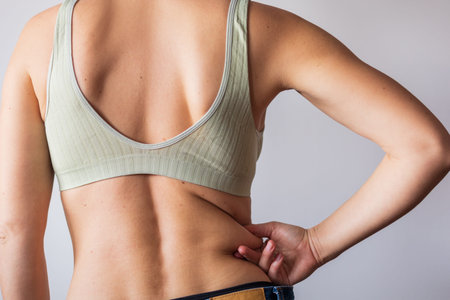 girl touches the side, folds of fat, the problem of obesity. high quality photo