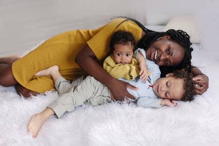 African-American mother with baby smiles and rejoices on beige background Minimalist portraits, space for textの写真素材