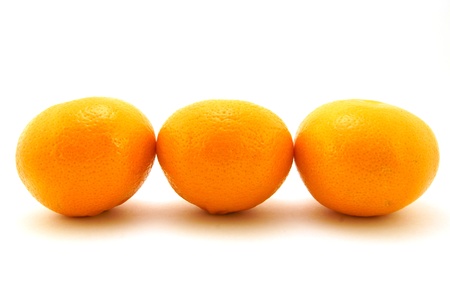 Tangerines ripe, three pieces, are located in one rowの写真素材
