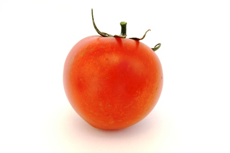 Tomato red, ripe with a tail, isolated on a white backgroundの写真素材