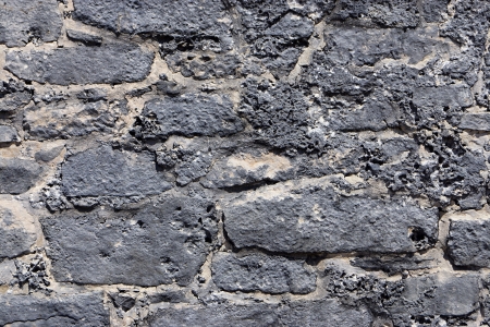 Old flat wall from a big gray stoneの写真素材