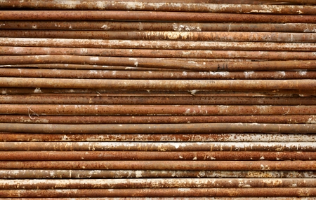 Old, rusty, dirty pipes are piled horizontallyの写真素材