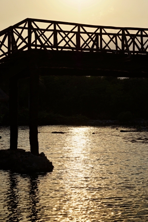 The bridge for pedestrians, is made of wooden boards and barsの写真素材