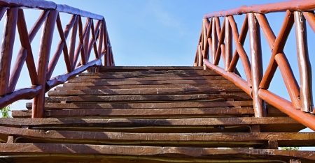 The bridge for pedestrians, is made of wooden boards and barsの写真素材